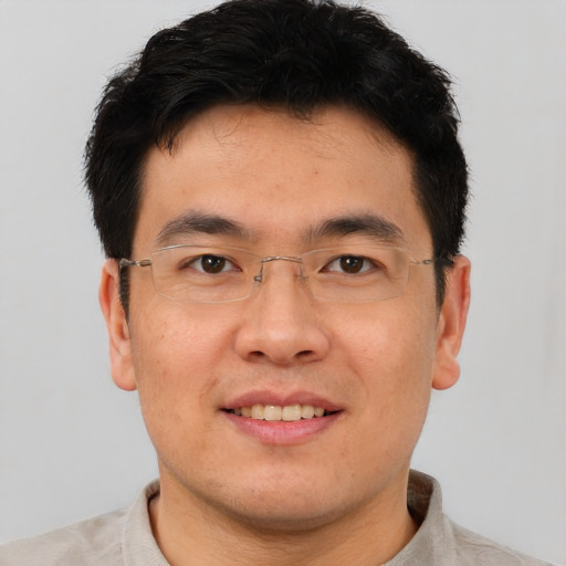 Joyful asian young-adult male with short  brown hair and brown eyes
