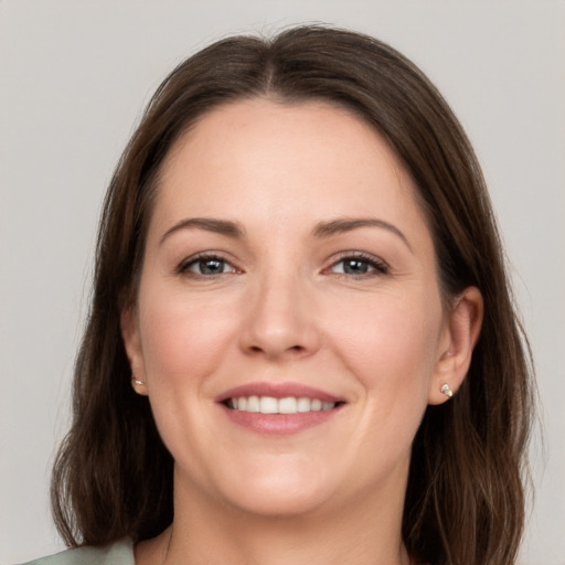 Joyful white young-adult female with long  brown hair and grey eyes