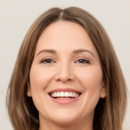 Joyful white young-adult female with long  brown hair and green eyes