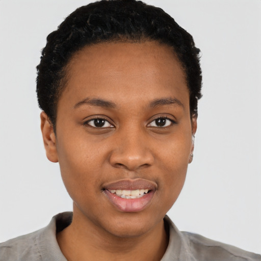 Joyful black young-adult female with short  black hair and brown eyes