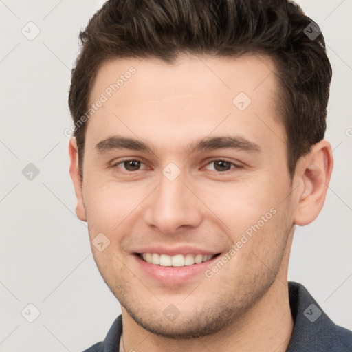 Joyful white young-adult male with short  brown hair and brown eyes