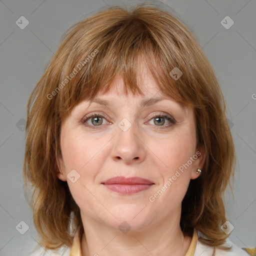 Joyful white adult female with medium  brown hair and blue eyes