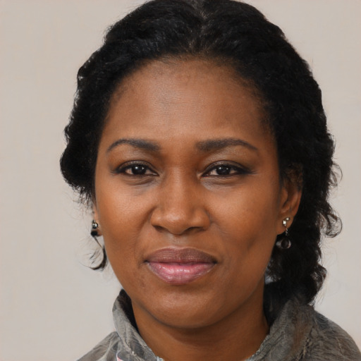 Joyful black adult female with medium  black hair and brown eyes