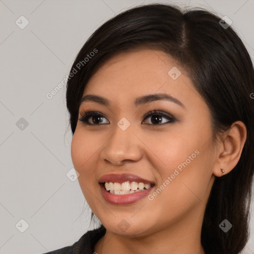 Joyful latino young-adult female with long  brown hair and brown eyes