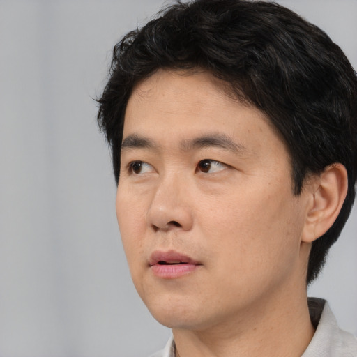 Neutral asian young-adult male with short  brown hair and brown eyes