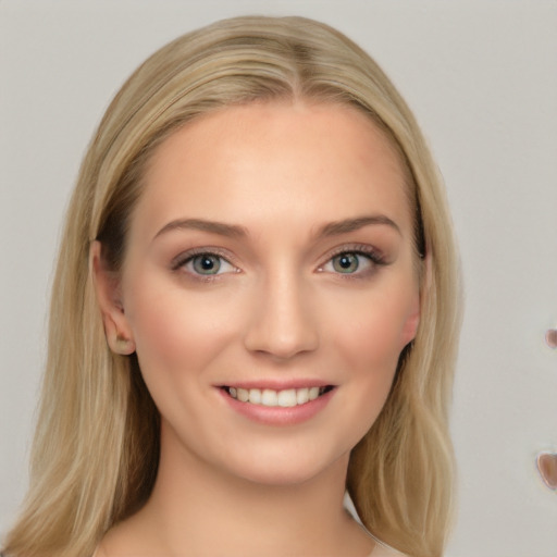 Joyful white young-adult female with long  brown hair and blue eyes