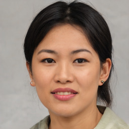 Joyful asian young-adult female with medium  brown hair and brown eyes