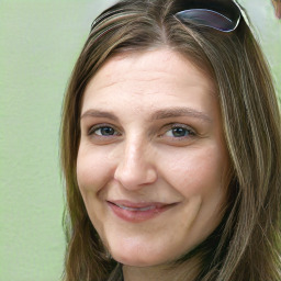 Joyful white young-adult female with long  brown hair and green eyes