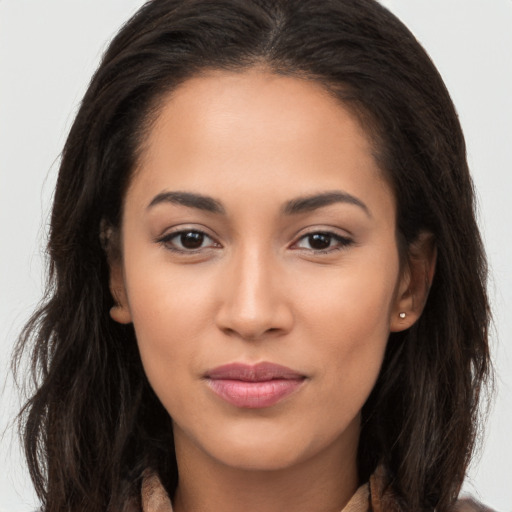 Joyful latino young-adult female with long  brown hair and brown eyes