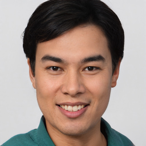 Joyful white young-adult male with short  black hair and brown eyes