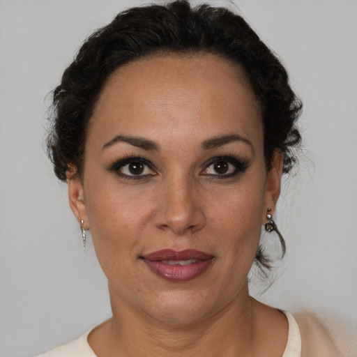 Joyful black adult female with short  brown hair and brown eyes