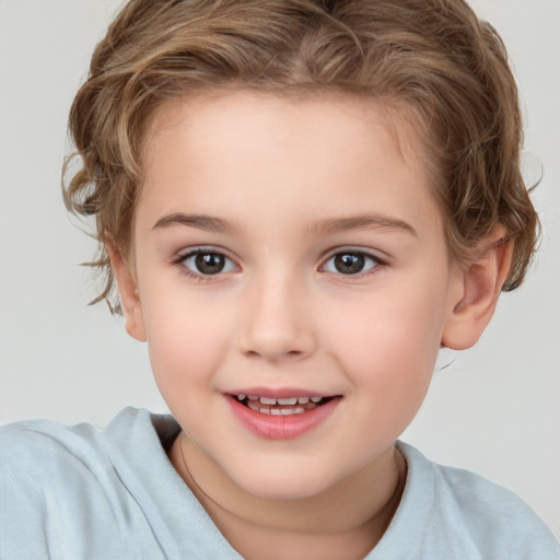 Joyful white child female with short  brown hair and brown eyes