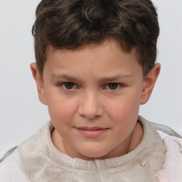 Joyful white child male with short  brown hair and brown eyes