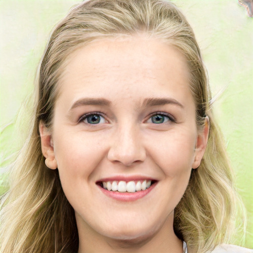 Joyful white young-adult female with long  brown hair and blue eyes