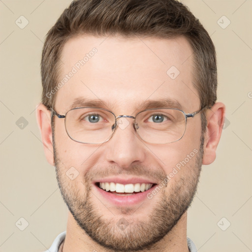 Joyful white adult male with short  brown hair and grey eyes