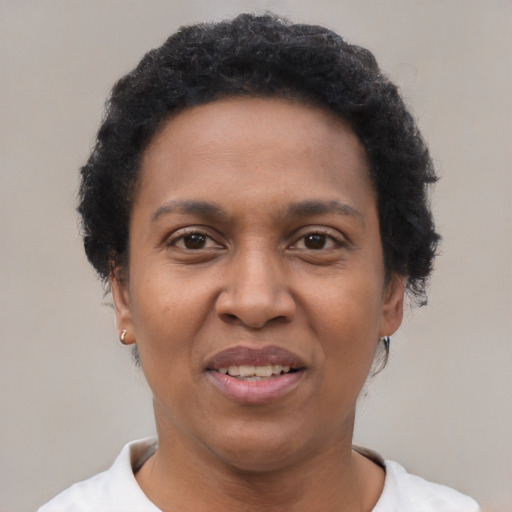 Joyful black adult female with short  brown hair and brown eyes