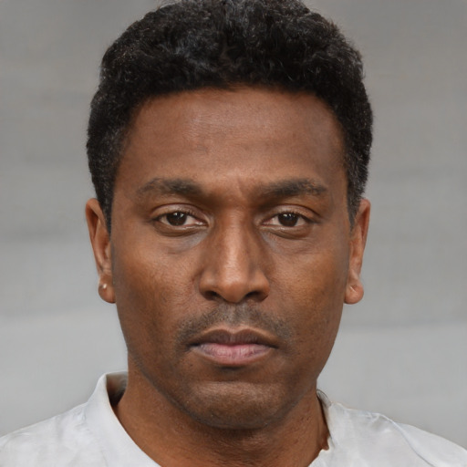 Neutral black young-adult male with short  black hair and brown eyes