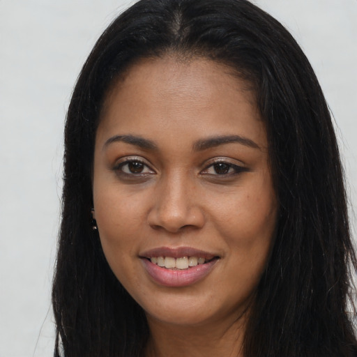 Joyful latino young-adult female with long  brown hair and brown eyes