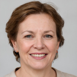 Joyful white adult female with medium  brown hair and grey eyes