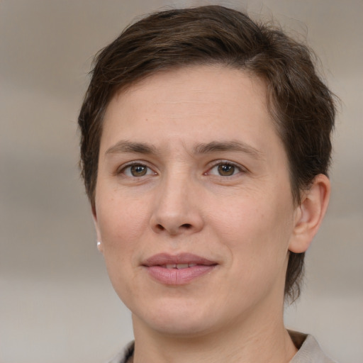 Joyful white adult female with medium  brown hair and brown eyes