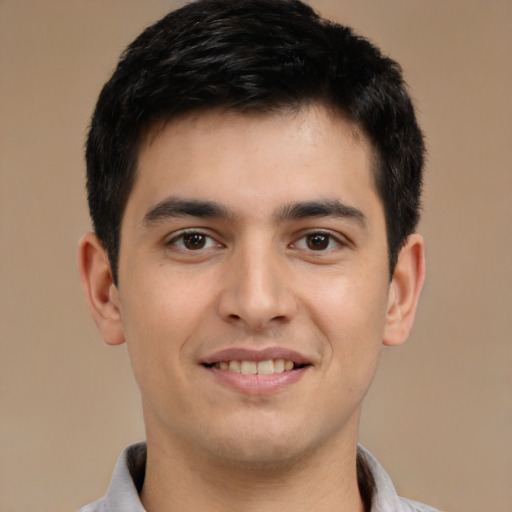 Joyful asian young-adult male with short  brown hair and brown eyes