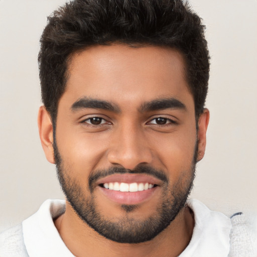 Joyful latino young-adult male with short  brown hair and brown eyes