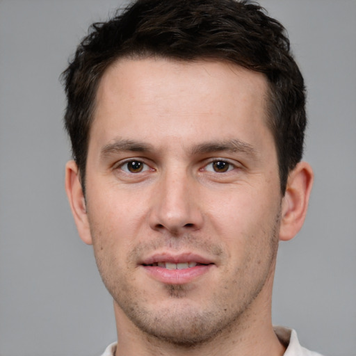 Joyful white young-adult male with short  brown hair and brown eyes