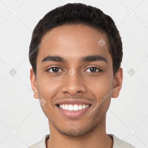 Joyful latino young-adult male with short  brown hair and brown eyes