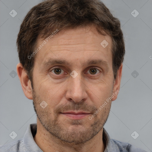 Joyful white adult male with short  brown hair and brown eyes