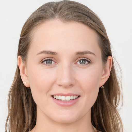 Joyful white young-adult female with long  brown hair and blue eyes