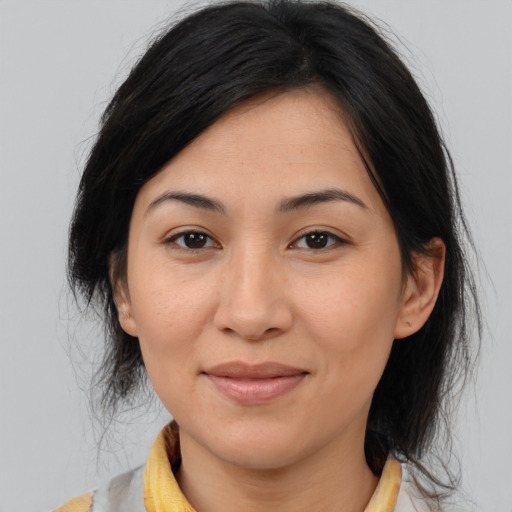 Joyful asian young-adult female with medium  brown hair and brown eyes