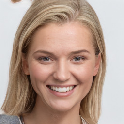 Joyful white young-adult female with medium  brown hair and blue eyes