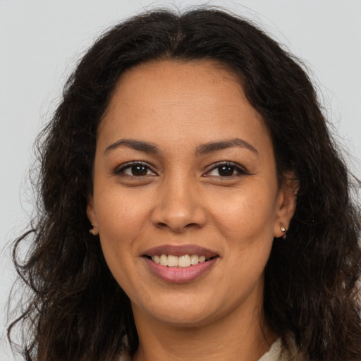 Joyful latino young-adult female with long  brown hair and brown eyes