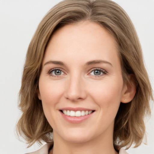 Joyful white young-adult female with medium  brown hair and green eyes