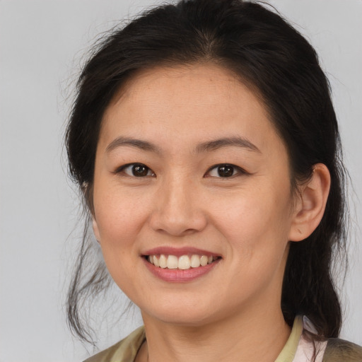 Joyful white young-adult female with medium  brown hair and brown eyes