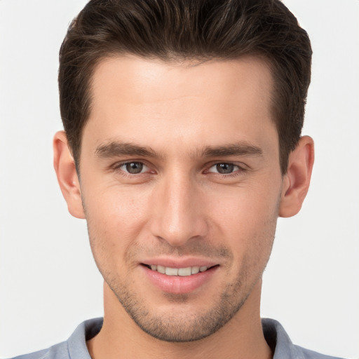 Joyful white young-adult male with short  brown hair and brown eyes