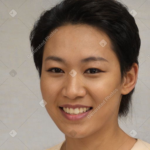 Joyful asian young-adult female with medium  black hair and brown eyes