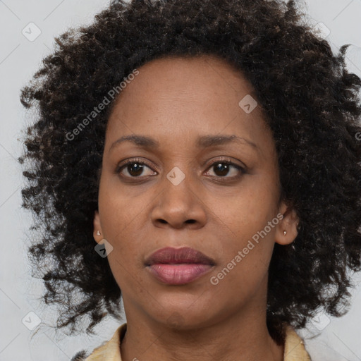 Joyful black adult female with medium  brown hair and brown eyes