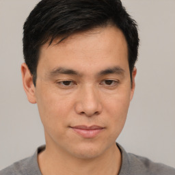 Joyful asian young-adult male with short  brown hair and brown eyes