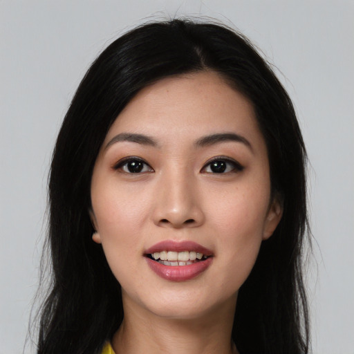 Joyful asian young-adult female with long  black hair and brown eyes