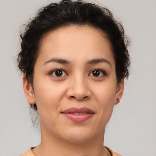 Joyful latino young-adult female with short  brown hair and brown eyes