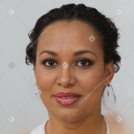 Joyful black adult female with short  brown hair and brown eyes