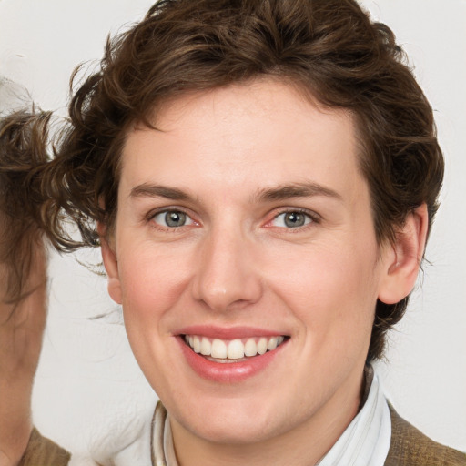 Joyful white young-adult female with medium  brown hair and blue eyes