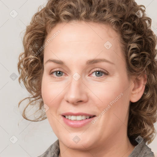 Joyful white young-adult female with medium  brown hair and blue eyes