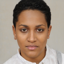 Joyful black young-adult female with short  black hair and brown eyes