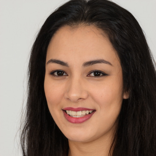 Joyful asian young-adult female with long  brown hair and brown eyes