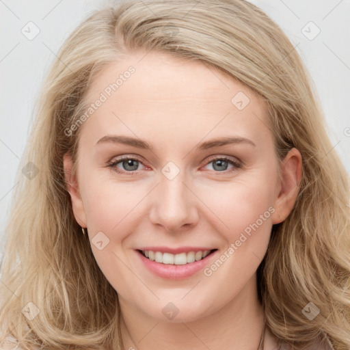 Joyful white young-adult female with long  brown hair and blue eyes