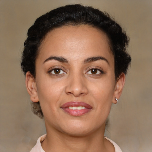 Joyful latino young-adult female with short  brown hair and brown eyes