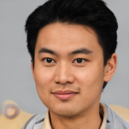 Joyful asian young-adult male with short  black hair and brown eyes