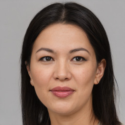 Joyful white adult female with long  brown hair and brown eyes